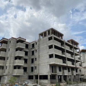 building under construction with storm clouds and blue sky